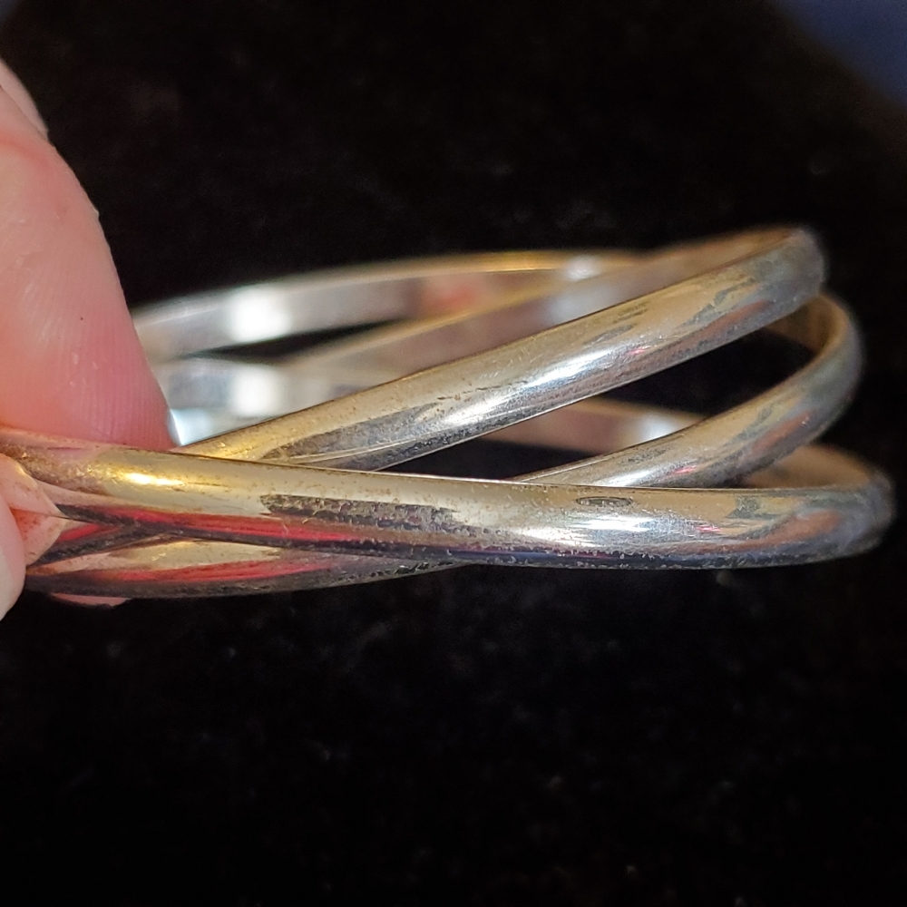 Silvertone set of three entertwined bangle bracelets